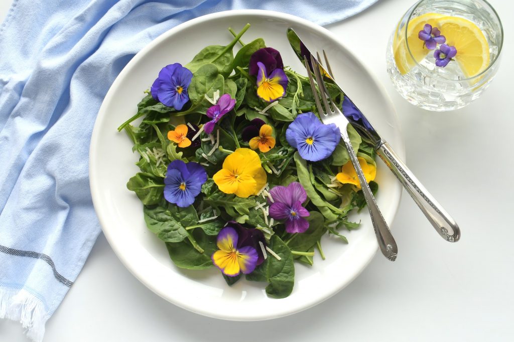 Fresh spring salad baby spinach arugula pansies & violets. Garden party bridal shower ladies lunch